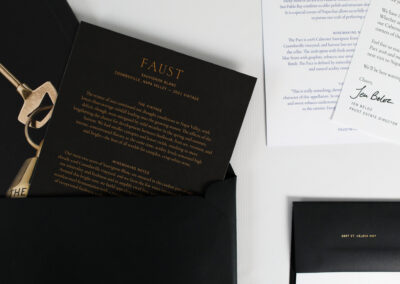 A photo of printed marketing collateral produced by Qualprint for Faust, a wine brand.
