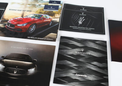 A photo of printed marketing collateral for Maserati, produced by Qualprint