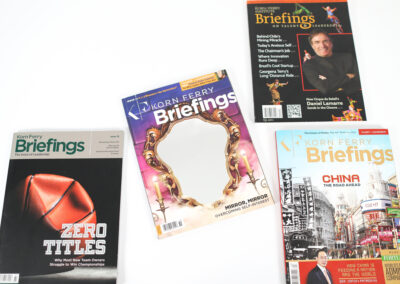 A photo of several issues of Korn Ferry Briefings printed catalogs produced by Qualprint