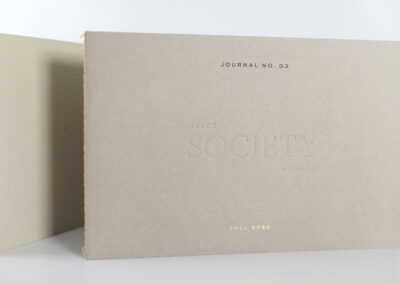 A photo of printed tasting journal for Heitz Society Cellar with debossed text, gold foil accents and sewn edges, produced by Qualprint.