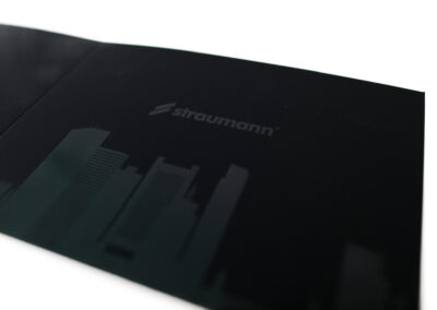 A printed piece of marketing collateral for Straumann US with white ink and raised UV spot coating
